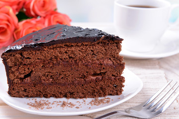 Delicious chocolate cake on plate on table on light background