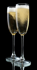 Glasses of champagne, on black background