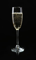 Glass of champagne, on black background