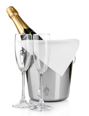 Bottle of champagne in pail and empty glasses, isolated on