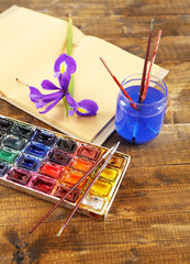 Composition with colorful watercolors, brushes and sketcher