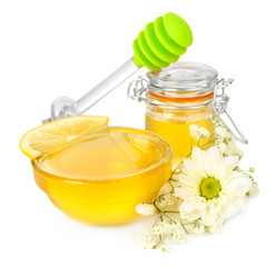 Sweet honey with lemon isolated on white