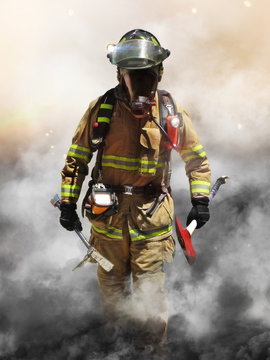 A firefighter pierces through a wall of smoke