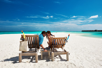 Couple relax on a beach at Maldives