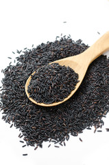 Rice berry on a wooden ladle. On a white background.