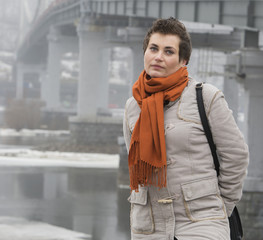 Portrait of young woman standing on the bridge