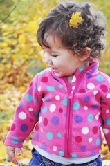 Little girl in the autumn forest