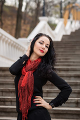 Fototapeta premium Beautiful Woman in warm autumn day on staircase