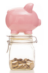 Piggy bank and money jar on white background