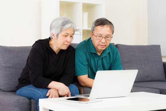 Asian Old Couple Using Laptop