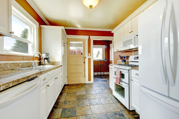 Orange kitchen room with white cabinets