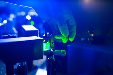 Quantum optics - hand of a researcher adjusting a laser beam in