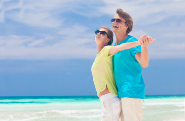 front view happy young couple on beach