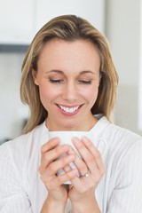Smiling woman sitting and holding mug