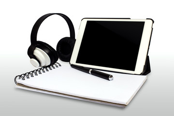 white tablet computer,paper,pen and headphone isolated.