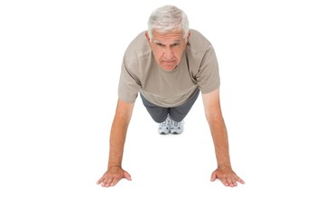 Portrait of a senior man doing push ups