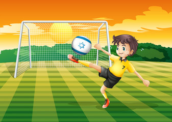 Fototapeta premium A girl kicking the ball with the Israel flag