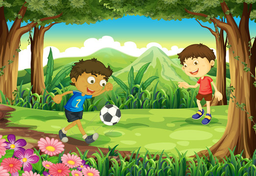 A forest with two boys playing soccer