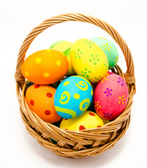 Colorful handmade easter eggs in the basket isolated