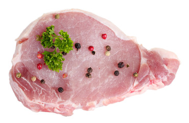 sliced raw pork steak with pepper and parsley isolated on white