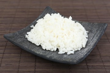 Cooked rice on bamboo background