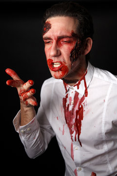 Psychopath licking blood from his fingers