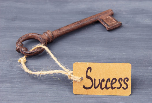Key to success, Conceptual photo. On color wooden background