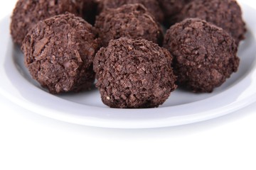 Delicious chocolates on plate close-up