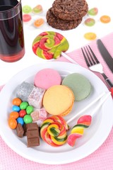 Different sweets on plate on table close-up