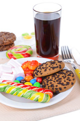 Different sweets on plate on table close-up