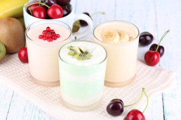 Delicious yogurt with fruits tastes in glasses and fresh fruits