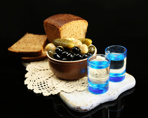 Composition with glasses  of vodka, and marinated  vegetables,