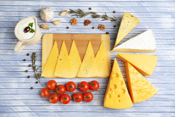 Different Italian cheese on wooden table