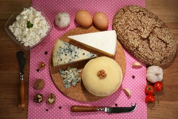 Still life with dairy products and bread on wooden table