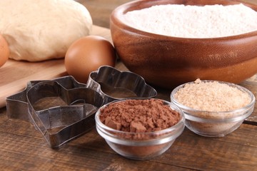 Ingredients for making cookies on wooden background