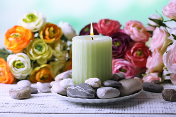 Composition with spa stones, candle  and flowers