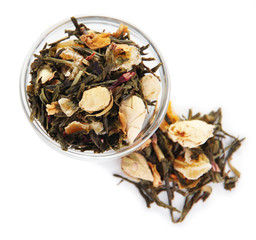 Dry green tea in bowl isolated on white