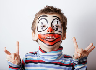 little cute boy with facepaint like clown, pantomimic expression