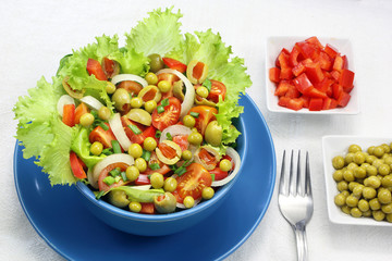 Vegetable salad with tomatoes, peppers and peas.