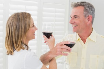 Side view of a couple toasting wine glasses