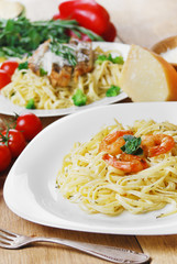 Pasta with shrimps and sauce on the wooden table