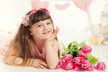 Obraz na płótnie Canvas portrait of a beautiful little girl with flowers