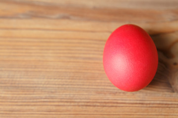 Red easter egg on wooden table