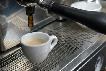 Fototapeta na wymiar Espresso pouring into a cup