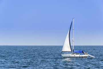Alone sailboat in the Mediterranean Sea