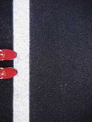 Red shoes on black road