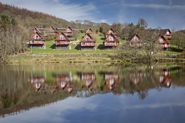 Holiday lodges by a lake.