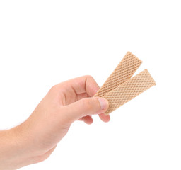 Hand holds wafer of chocolate.