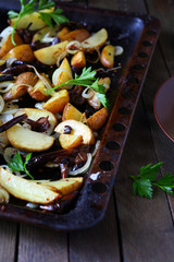 potatoes with mushrooms and onions on a baking sheet