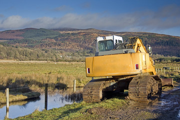 Digger Repairing Sea Wall